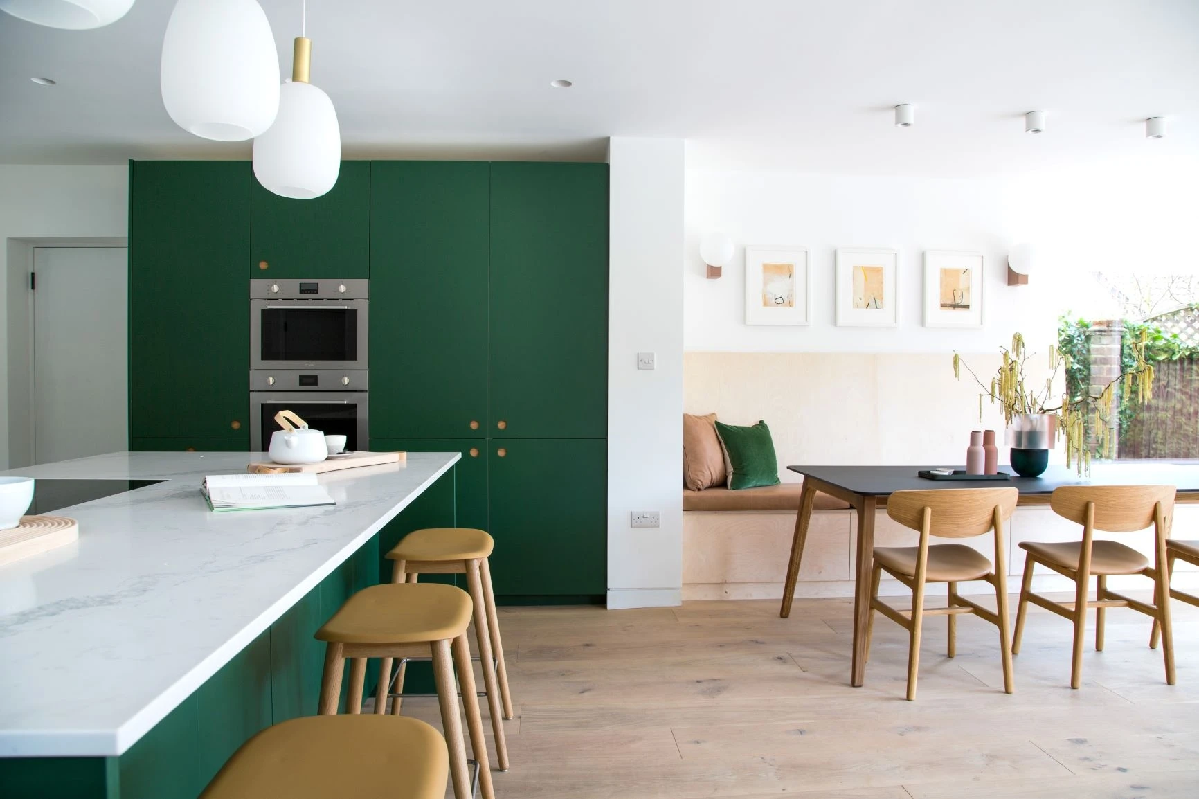 Oak accents echo the Ladbroke handle backs, bar stools, and chairs, blurring the lines between kitchen and surrounding environment.