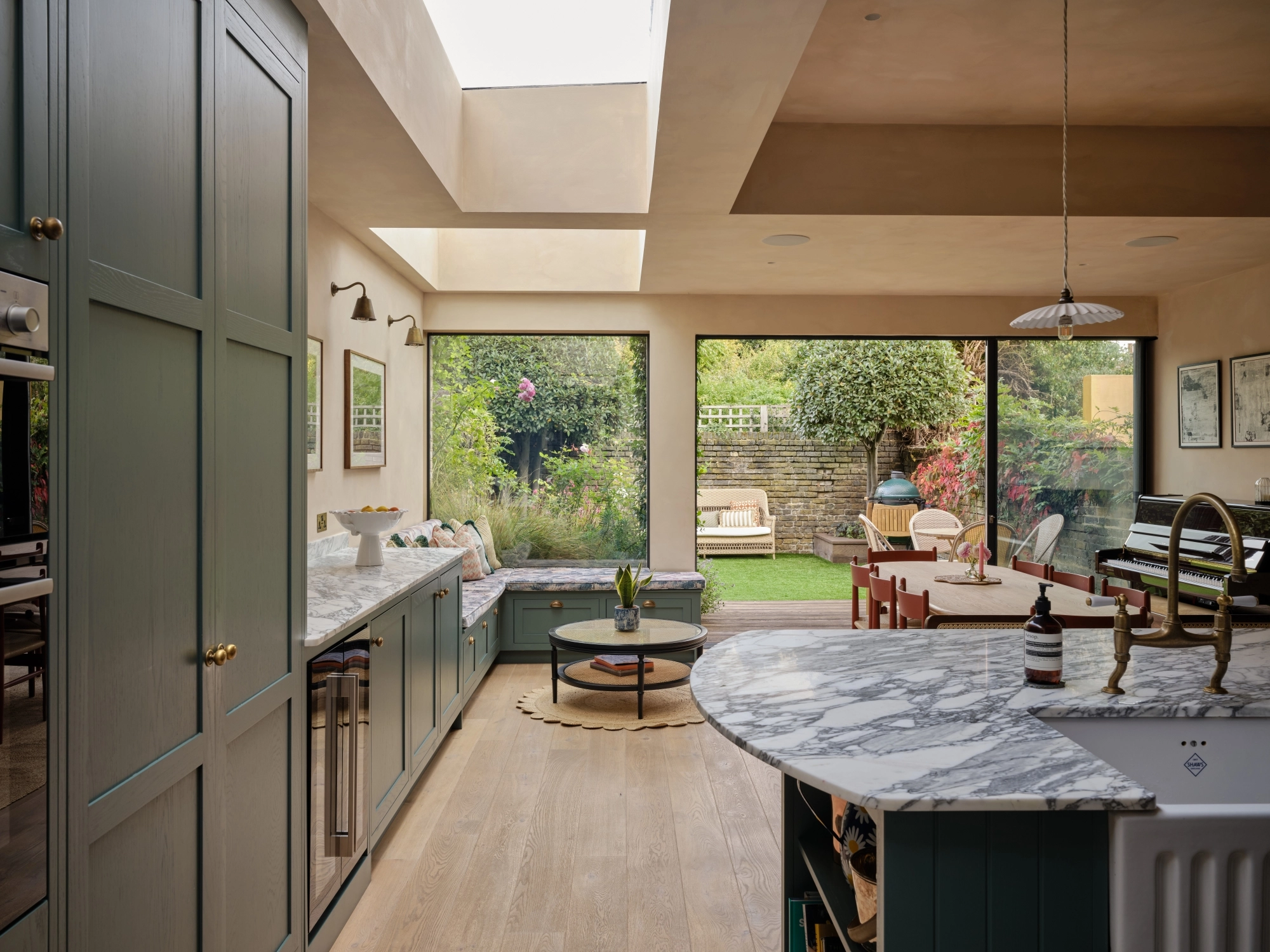 A wooden cabinet with glass doors displaying ceramic dishes, bowls, and a jug. Below is a light blue drawer set with a marbled countertop. Warm lighting highlights the textures and tones of the ceramics and wood