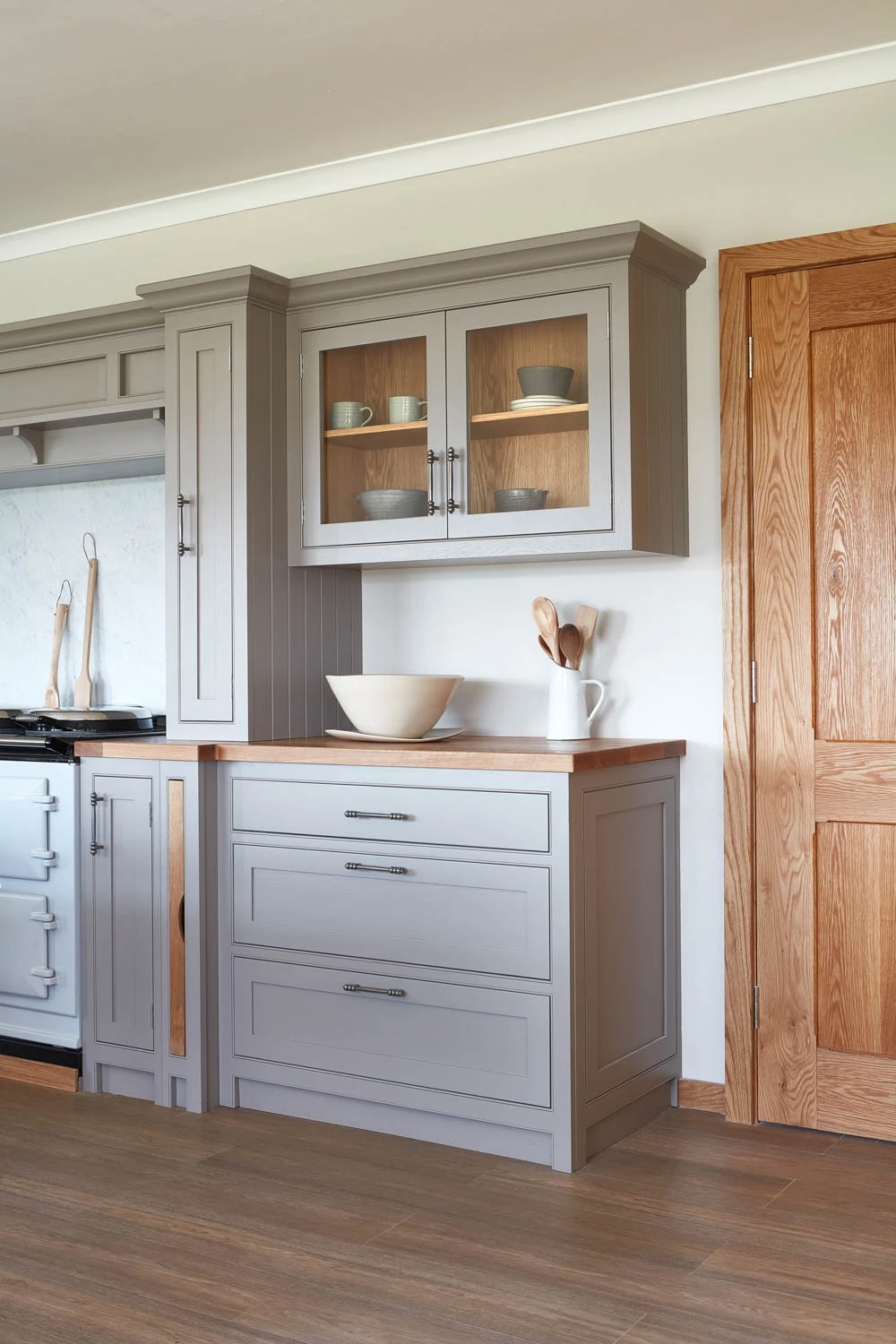 Oversized oak worktops add warmth and a luxurious touch, seamlessly tying together the traditional design and modern appliances.