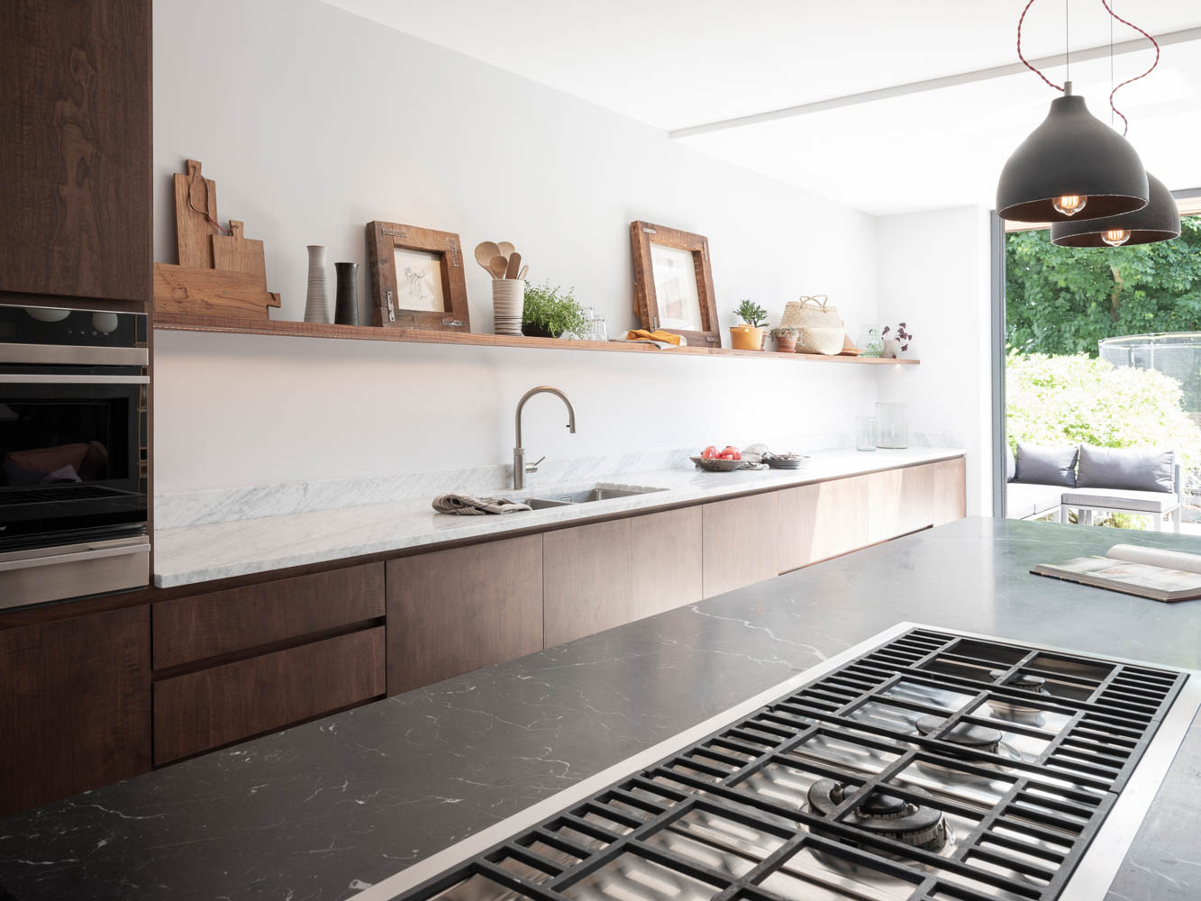 Traditional looking kitchen with walnut finish and handleless door design
